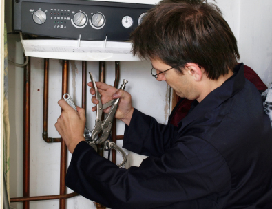 Plumber replacing a boiler